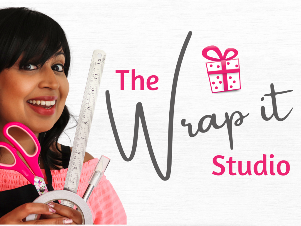 Tina posing with gift wrapping material with a title that reads The Wrap it Studio